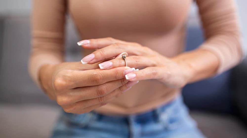 Woman Removing Wedding Ring